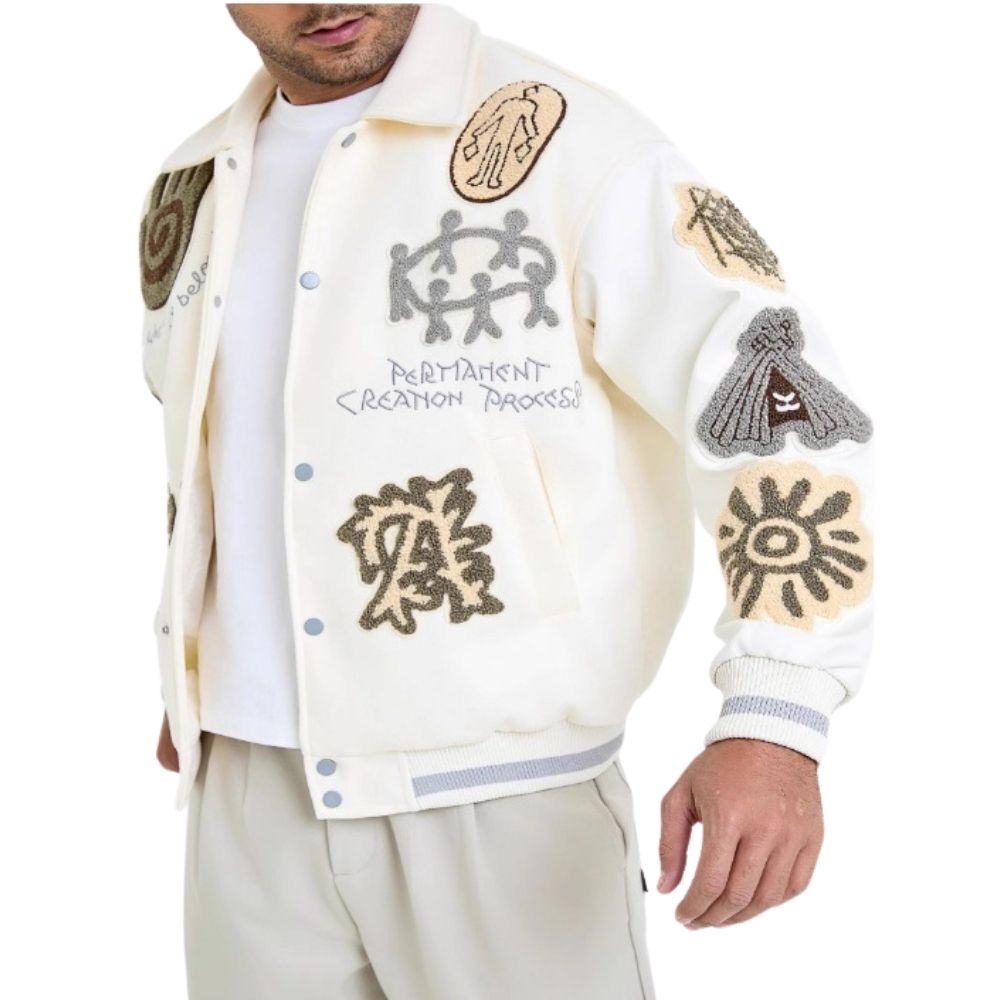 Man wearing a white jacket with embroidered designs and text on a white background
