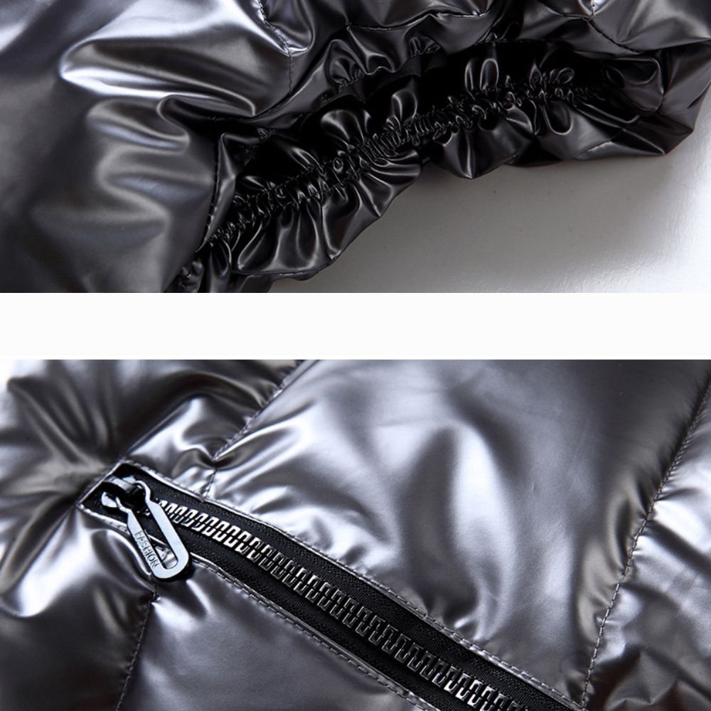 Close-up of a shiny metallic jacket with a zipper detail on a white background.