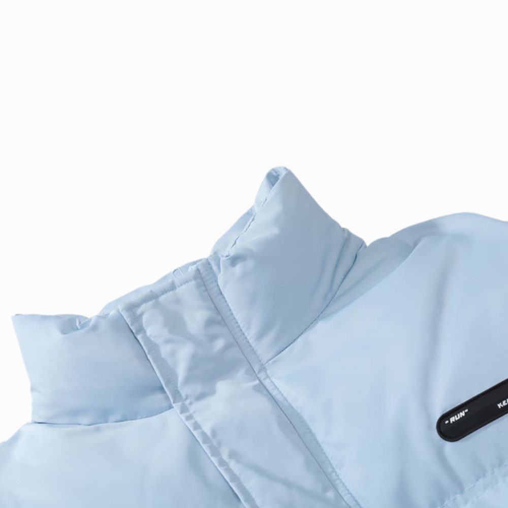 Light blue puffer vest with a brand label on a white background