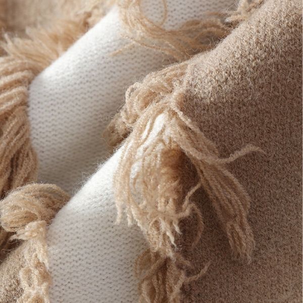 Close-up of beige and white textured cushions with frayed edges.