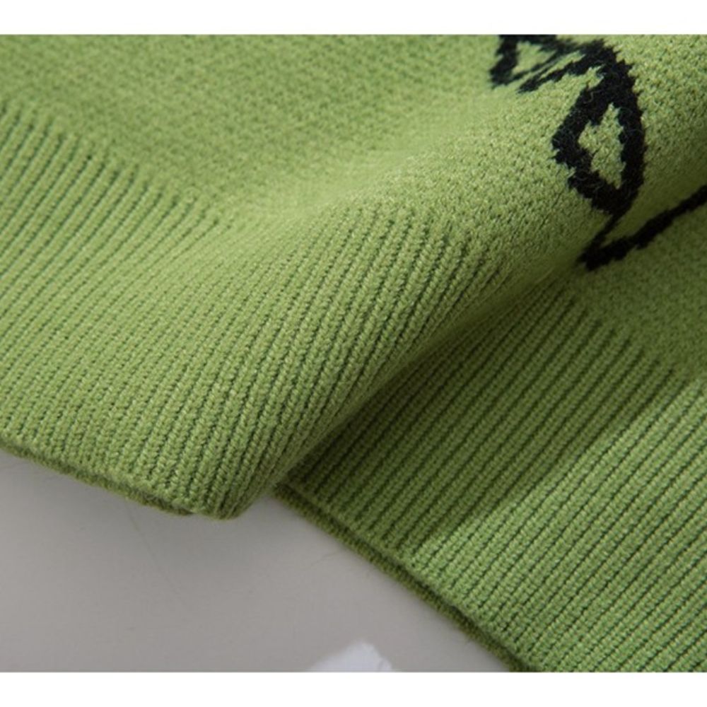 Close-up of green fabric with black pattern on a white background