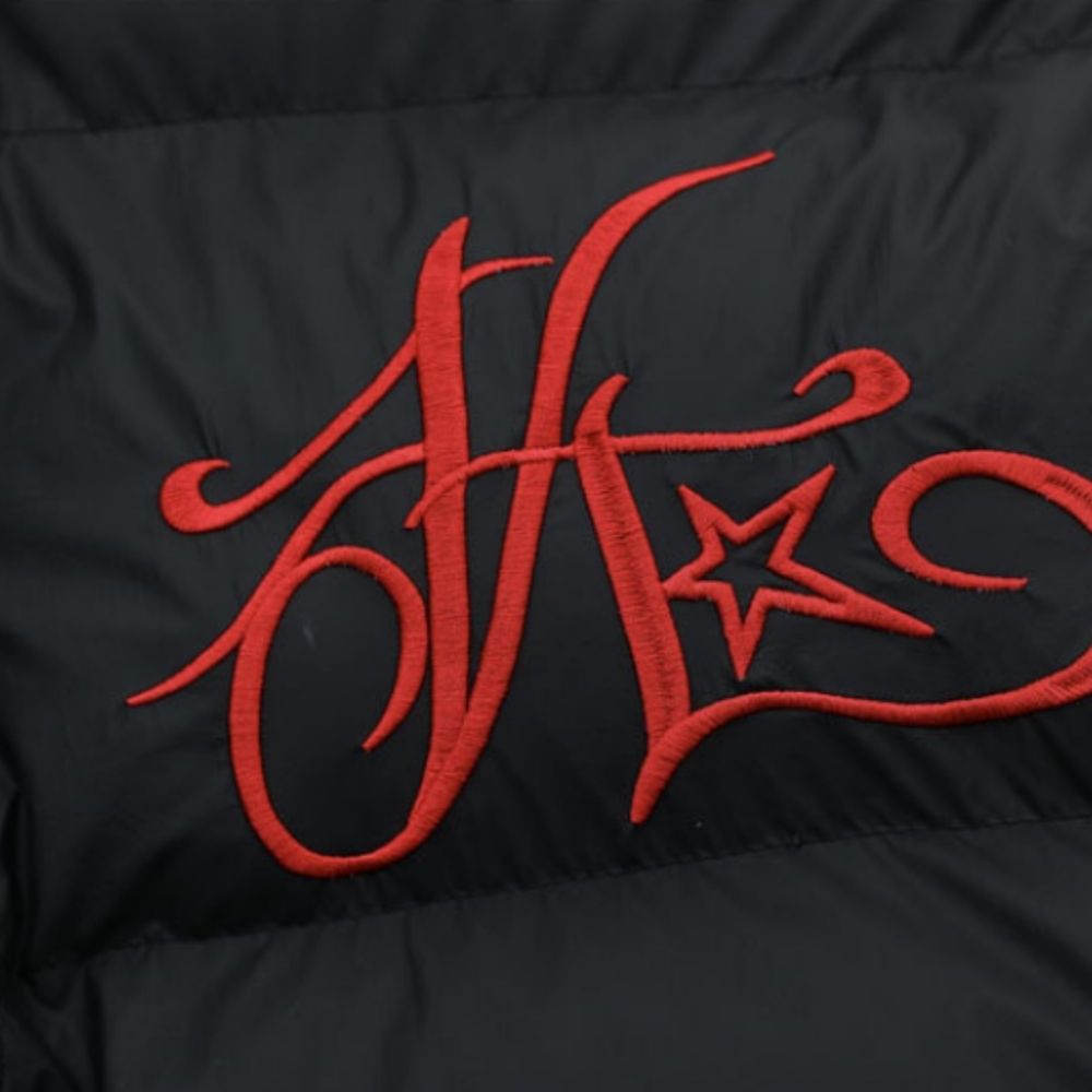 Red embroidered design on a black background