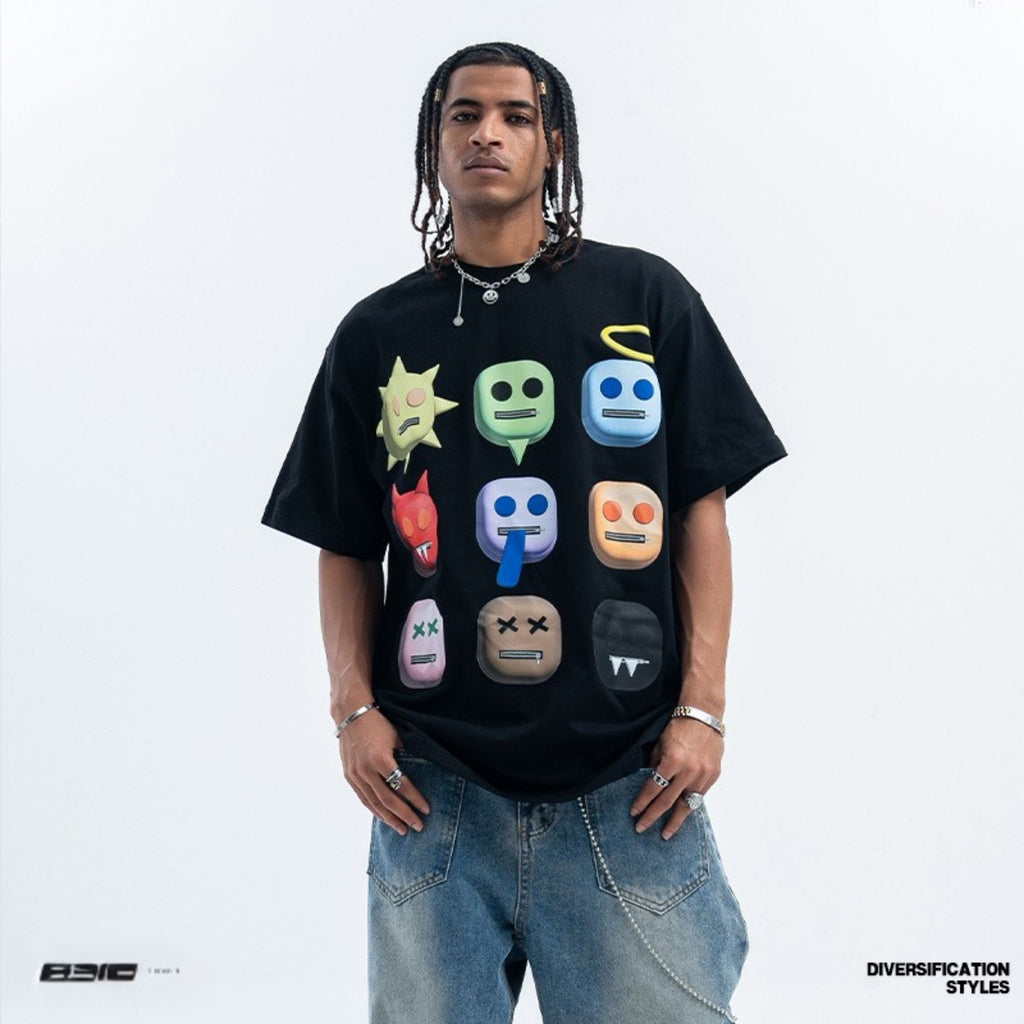 Person wearing a black t-shirt with colorful emoji designs on a white background