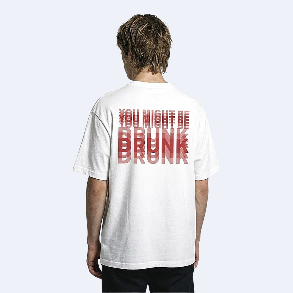 White. KRUX You Might Be Drunk oversized tee in white, worn by a male model — back view showing the red DRUNK print