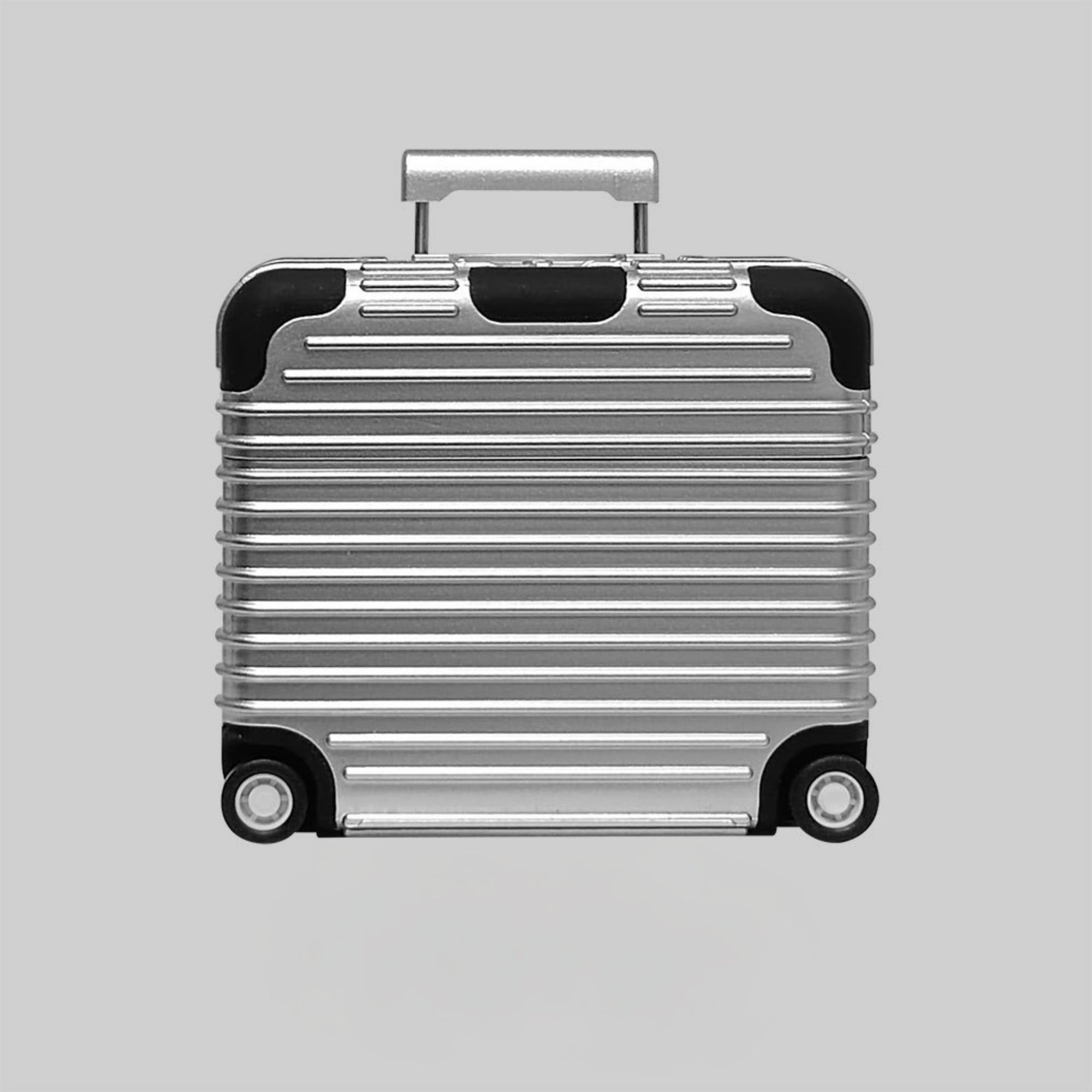 Silver suitcase AirPods case with black accents on a light gray background