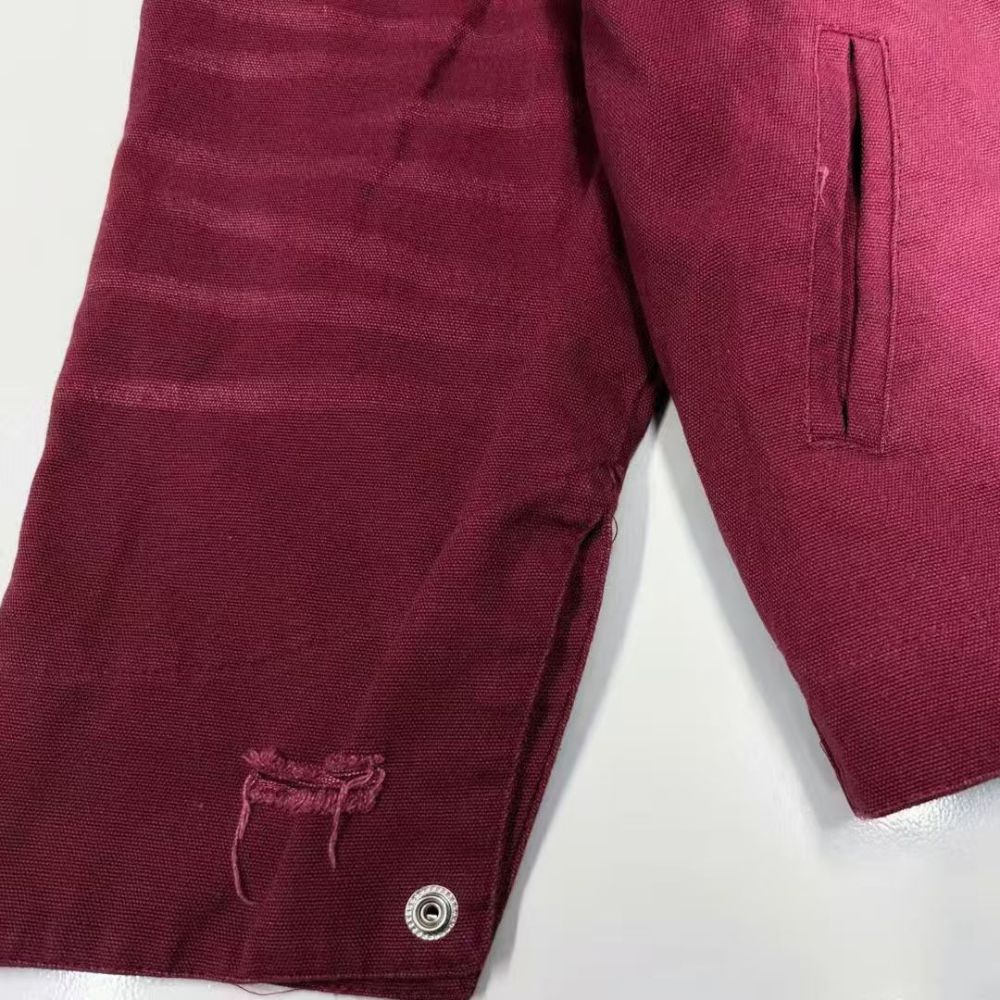 Maroon shorts with a button on a white background