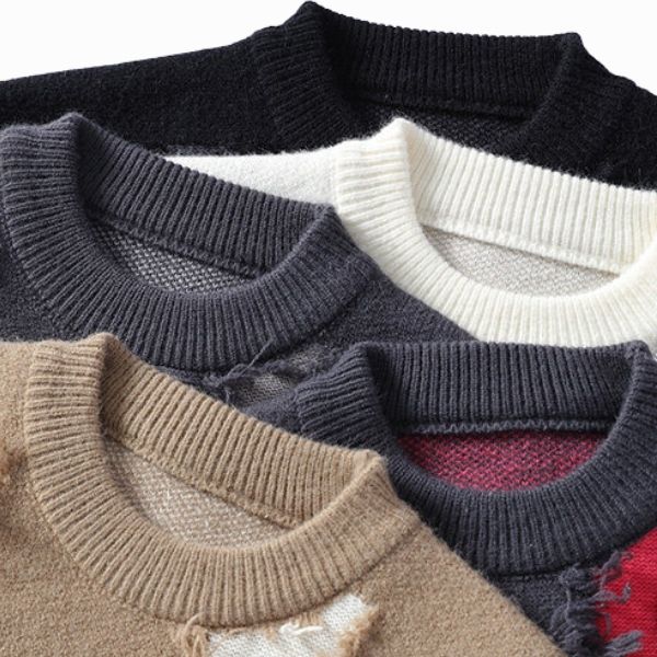 Close-up of various knitted sweaters with different color combinations.