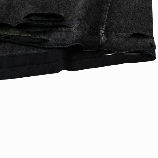 Close-up of a black shirt with distressed details on a white background