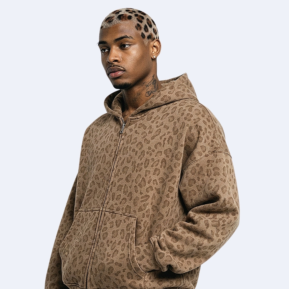 Brown. KRUX Feral brown leopard zip hoodie, side view on a male model