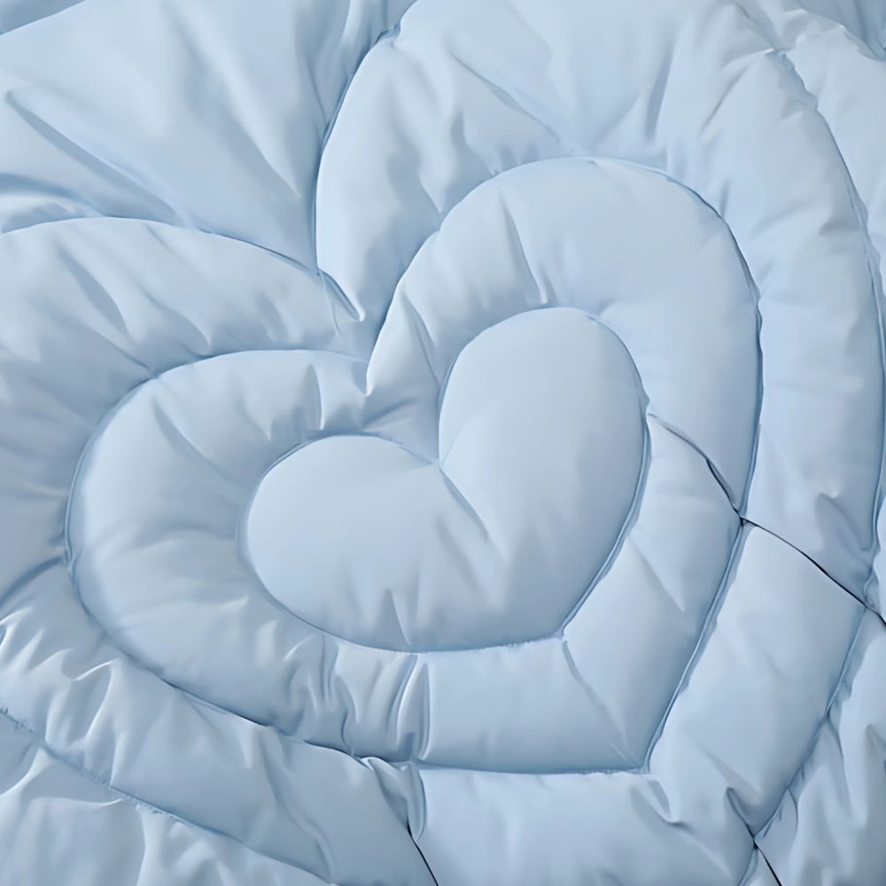 Light blue comforter with a heart shape in the center