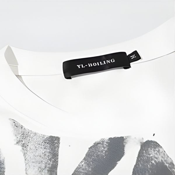 Close-up of a white garment with a black label on a light gray background