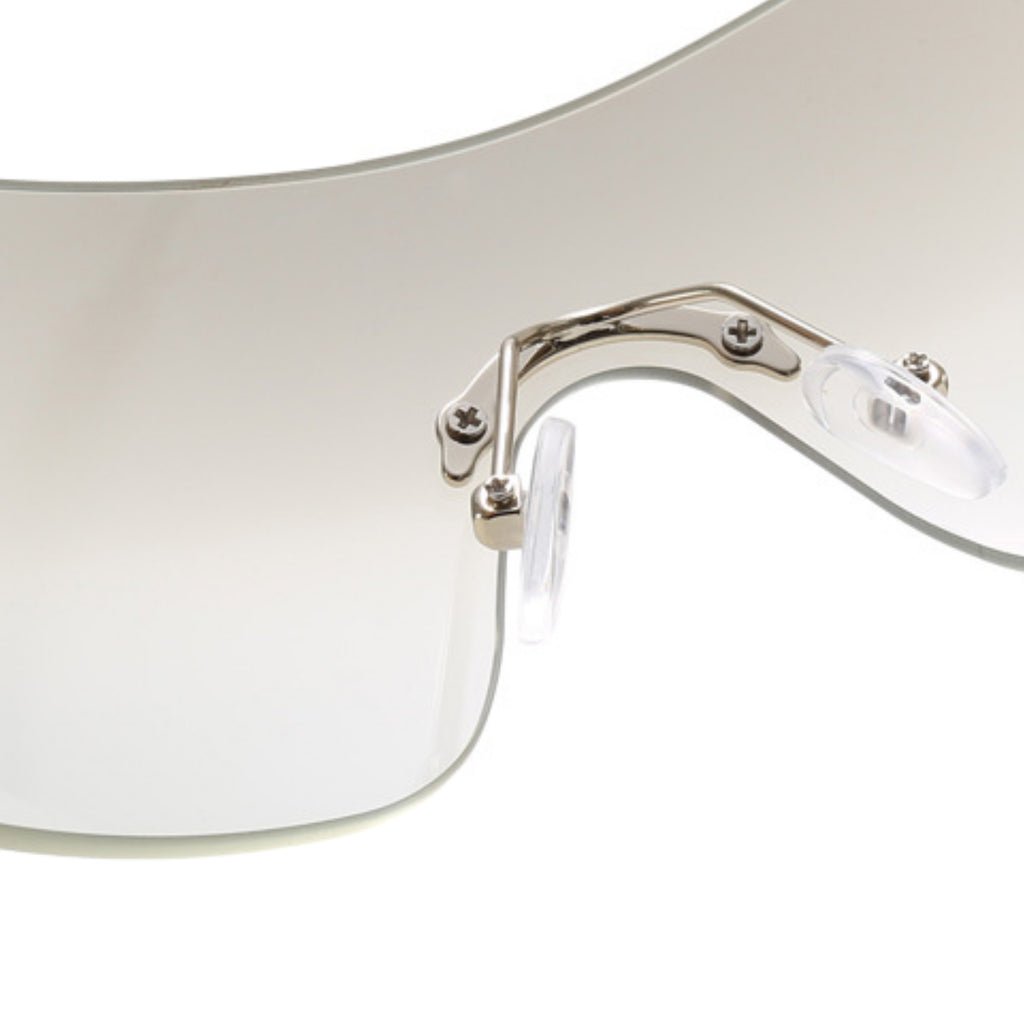 Close-up of a clear safety visor with metal frame on a white background