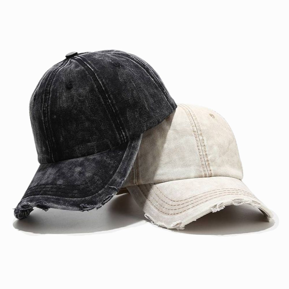 Two distressed denim caps, one black and one beige, on a white background.