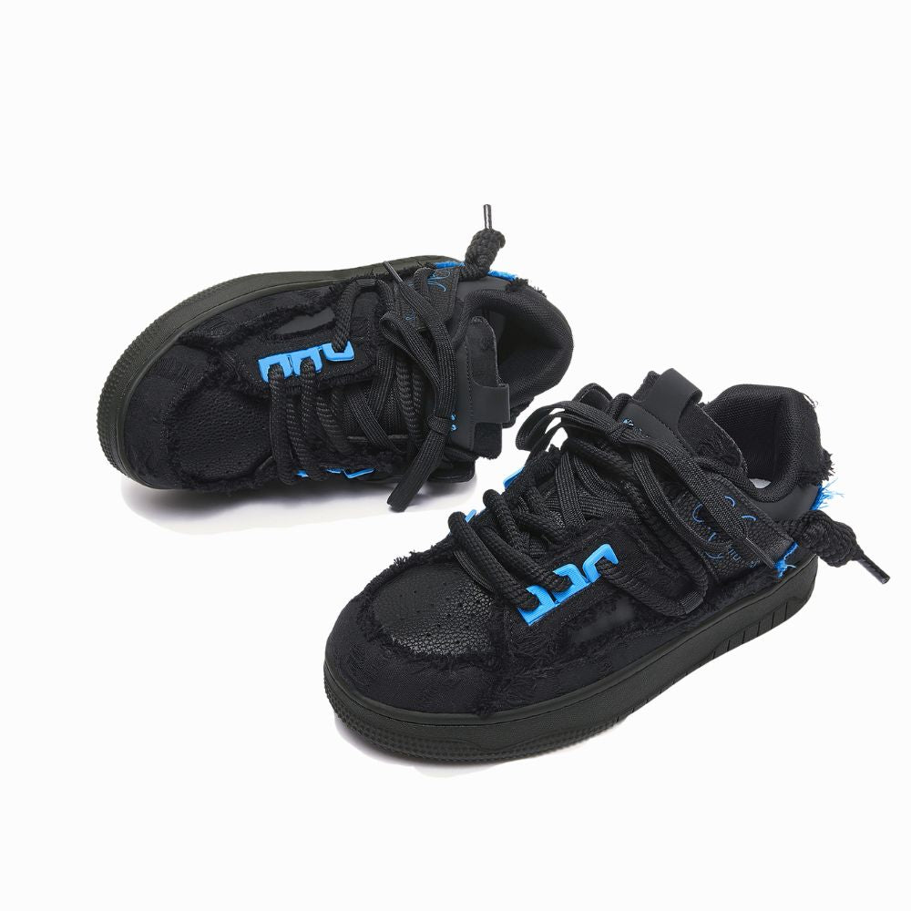 Black sneakers with blue accents on a white background