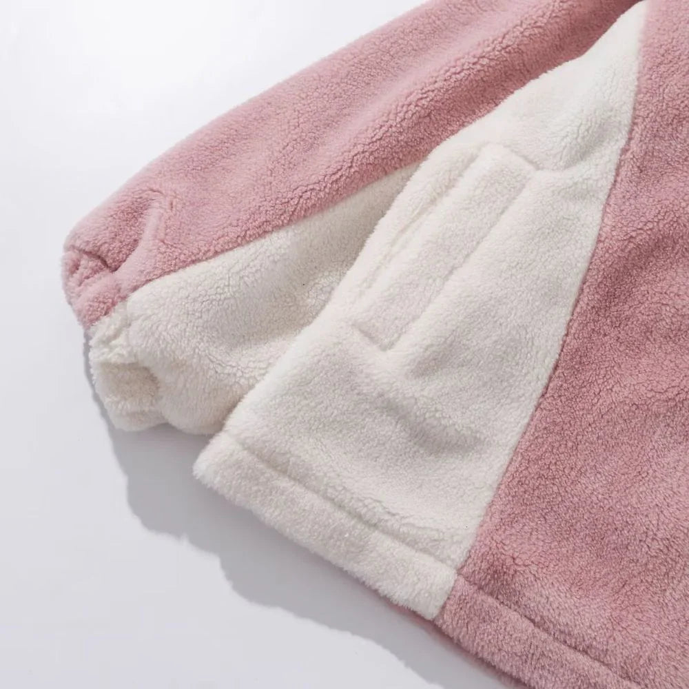 Close-up of a pink and white fleece blanket on a light gray background