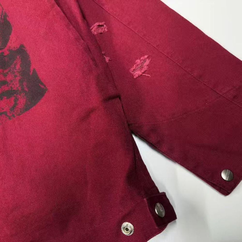 Close-up of a red jacket with black design on a white background