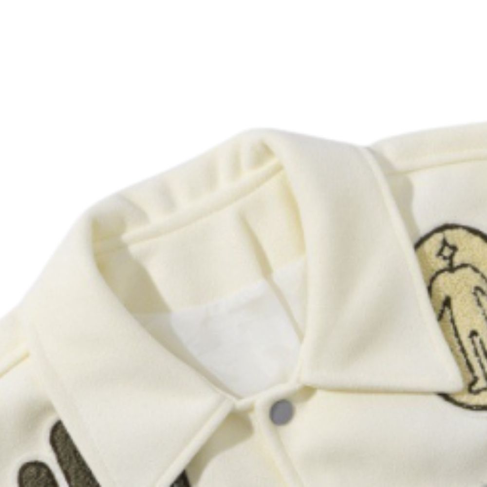 Close-up of a cream-colored garment with a logo on a white background