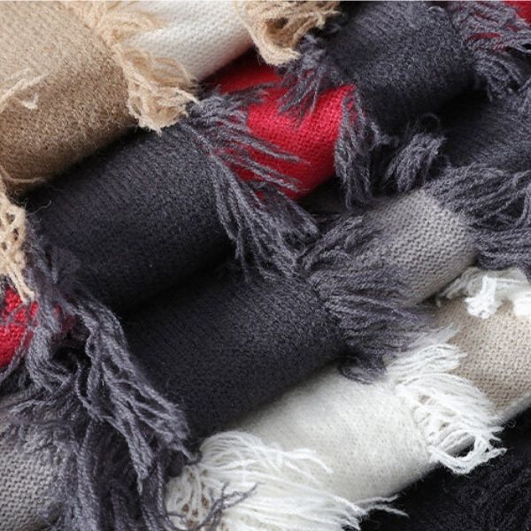 Close-up of textured fabric with fringes in various colors.