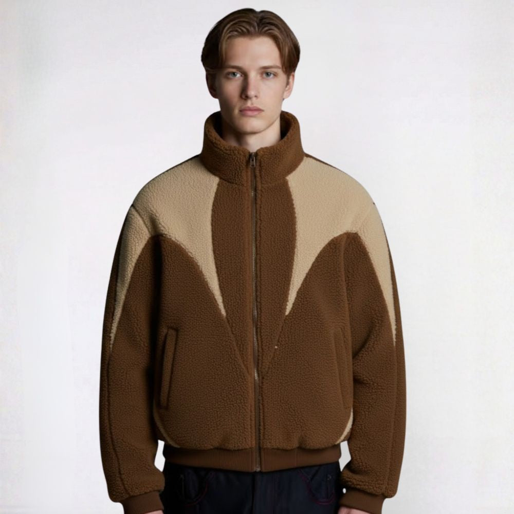 Man wearing a brown and beige color-blocked jacket on a white background