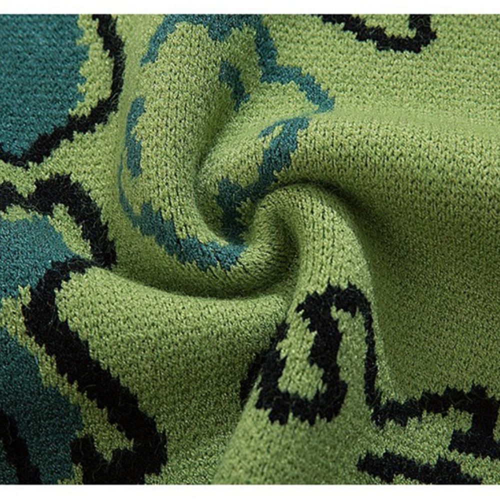 Close-up of green fabric with black and blue patterns