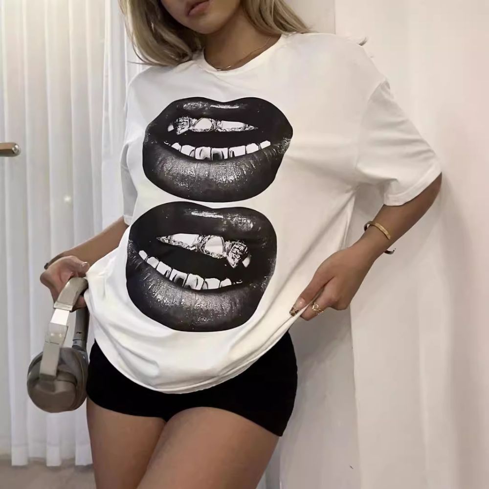 Person wearing a white t-shirt with black lips design.
