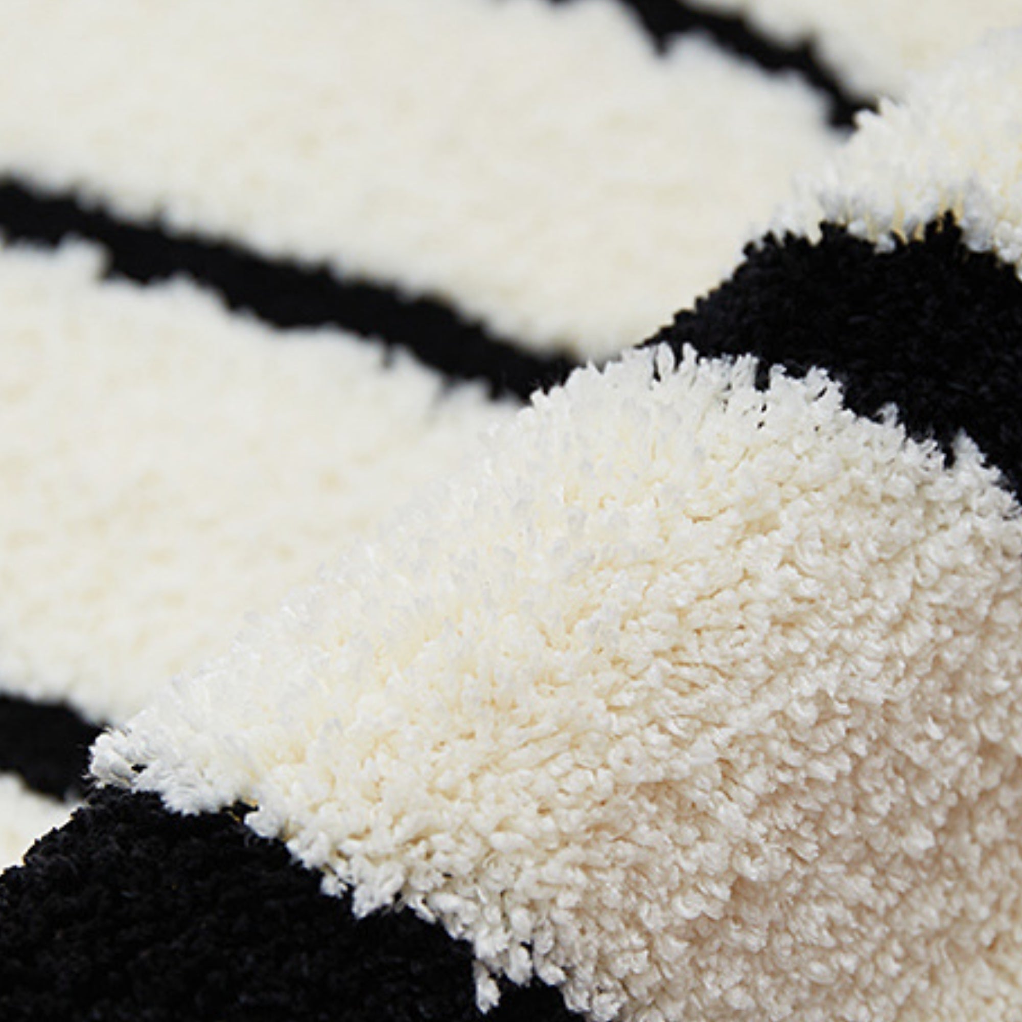 Close-up of a black and white striped textured rug