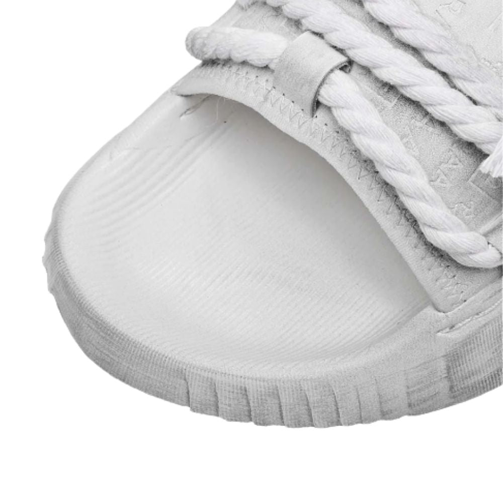 Close-up of a gray sneaker with white laces on a white background