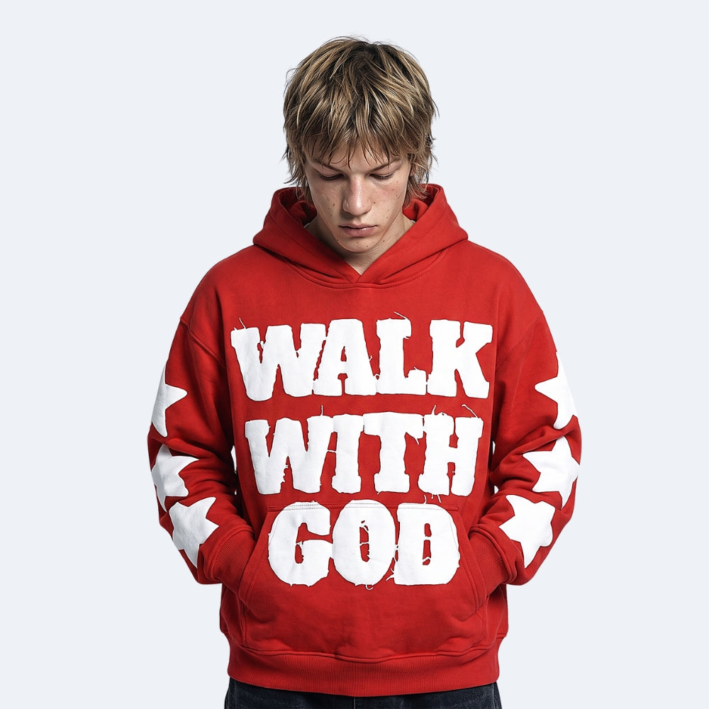 Red. A young man with blonde hair wearing a red hoodie with WALK WITH GOD printed in white across the front and white stars on the sleeves.