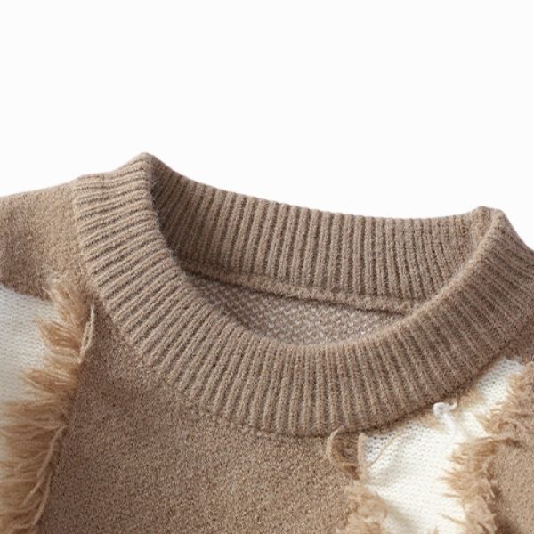 Close-up of a brown knitted sweater with frayed edges on a white background