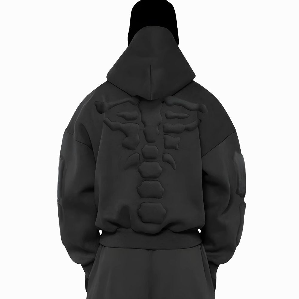 Black hoodie with skeleton design on the back worn by a person on a white background