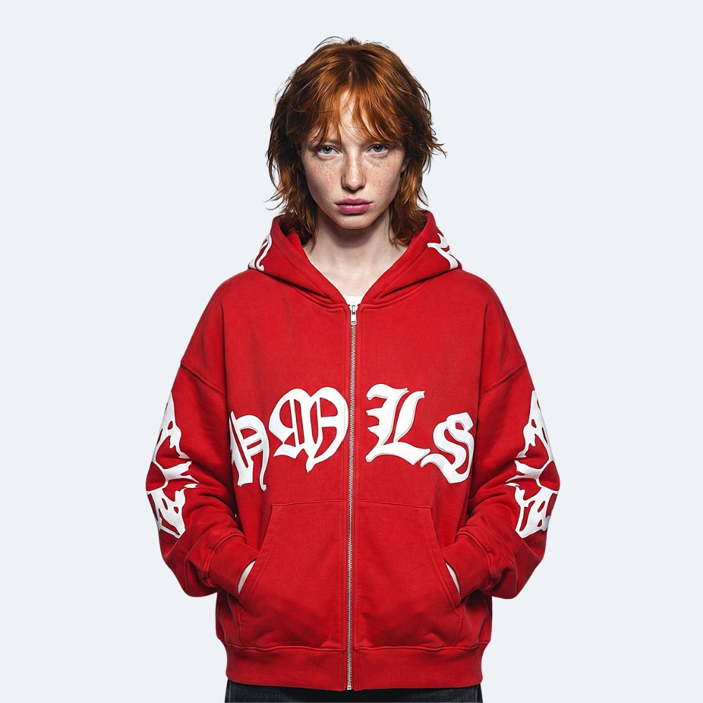 Red. A model with red hair wearing a red zip-up hoodie with white Gothic lettering on the front and sleeves.