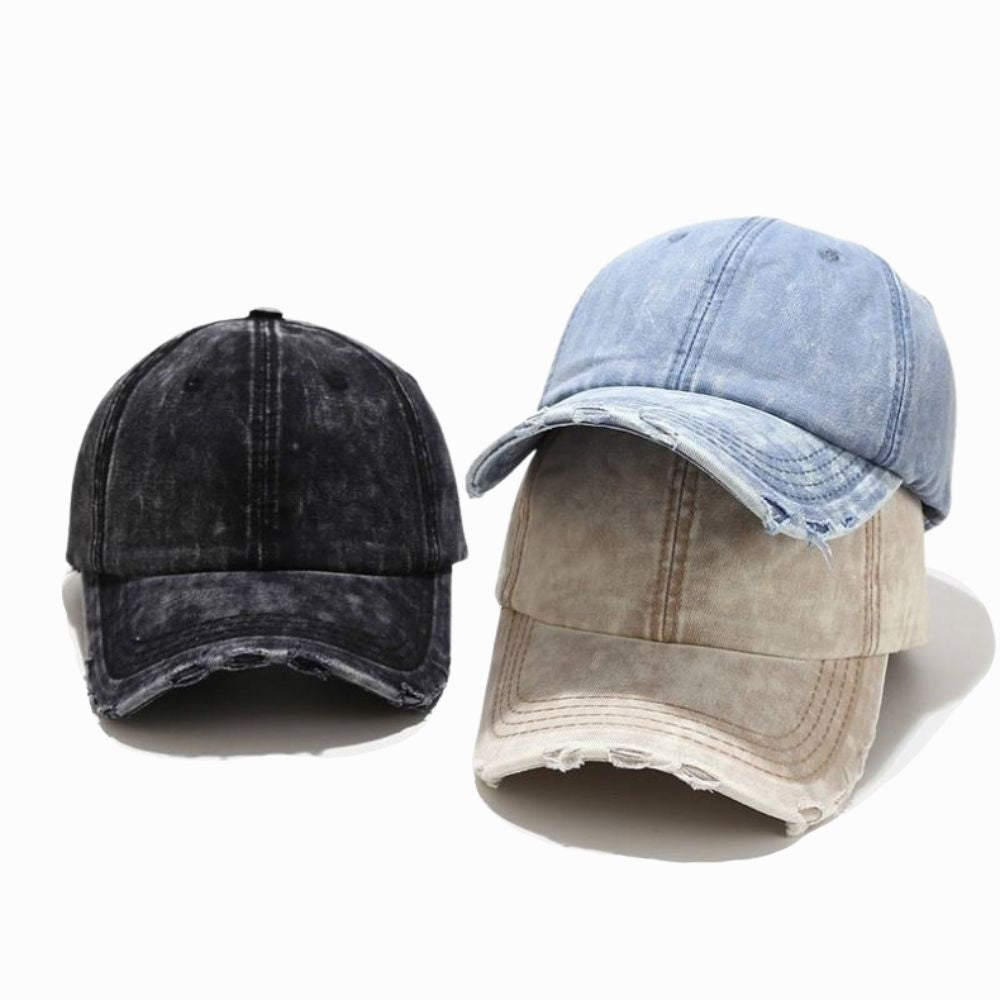 Three distressed denim caps in black, blue, and beige on a white background