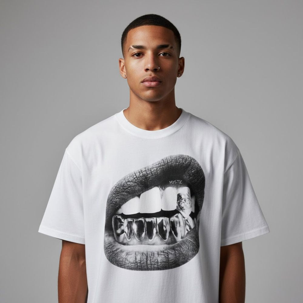 Person wearing a white t-shirt with a graphic design of lips and teeth on a gray background