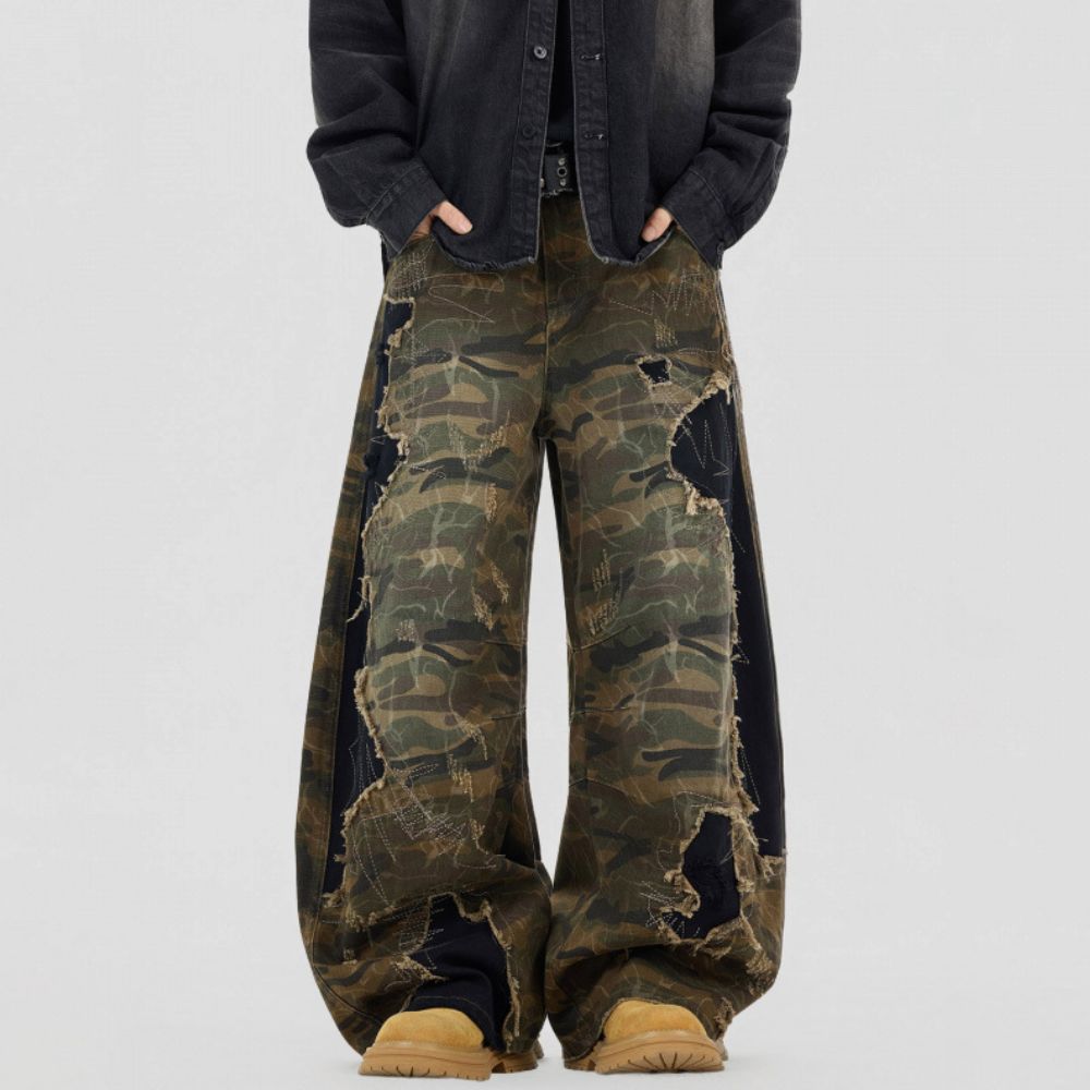 Person wearing camouflage pants with a plain background