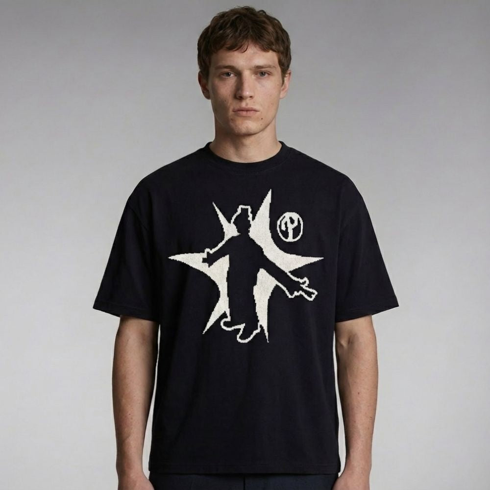 Man wearing a black t-shirt with a white graphic design on a plain background