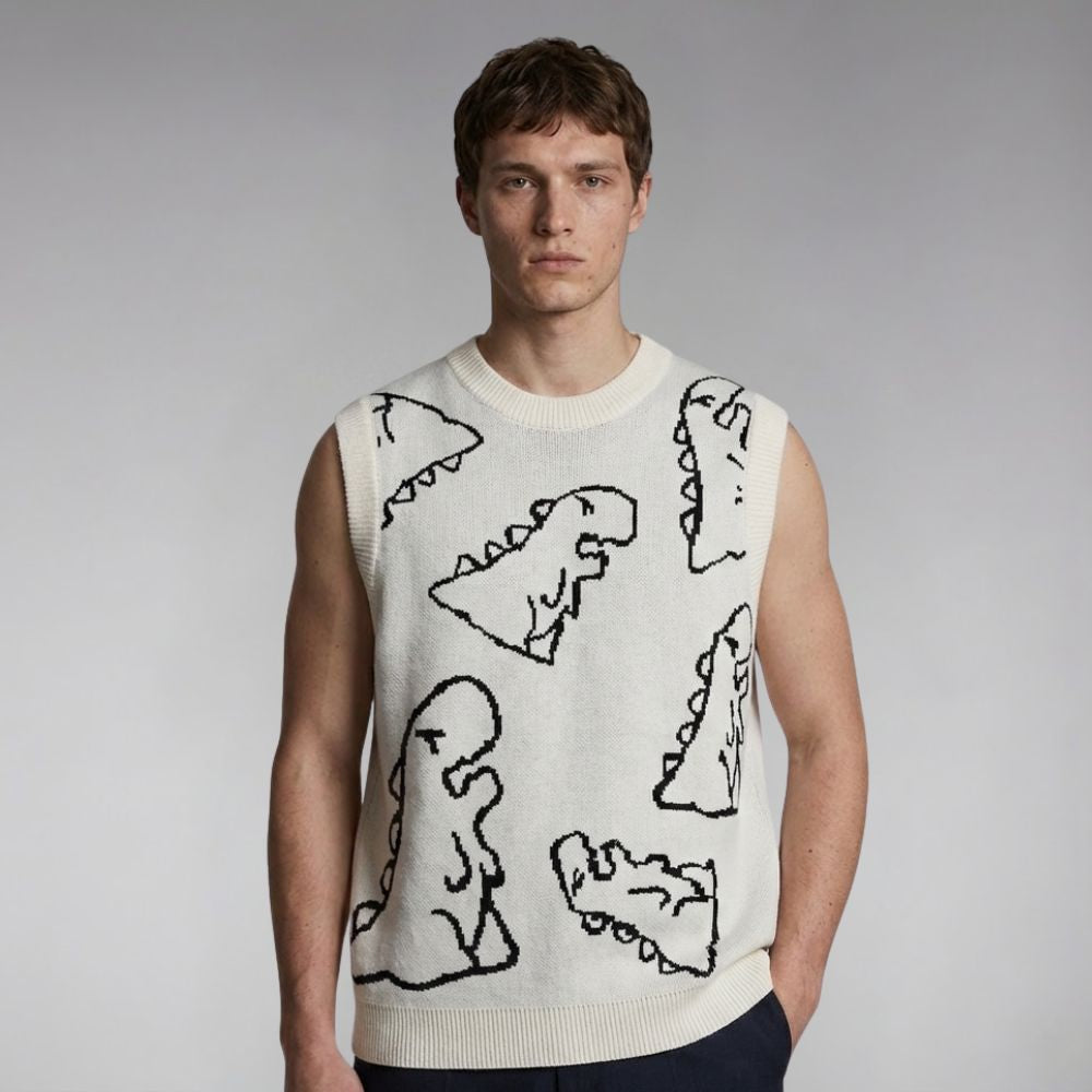 Man wearing a sleeveless sweater with dinosaur designs on a plain background