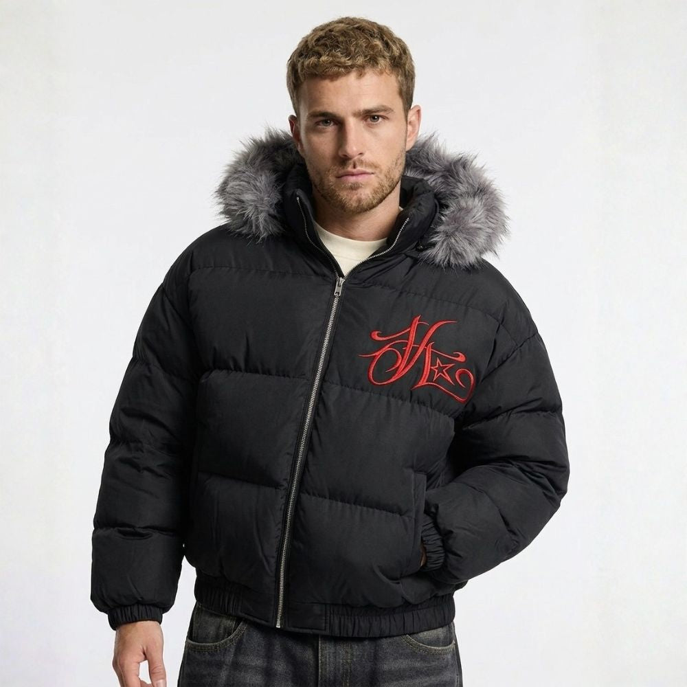 Man wearing a black puffer jacket with gray fur hood and red logo on a white background