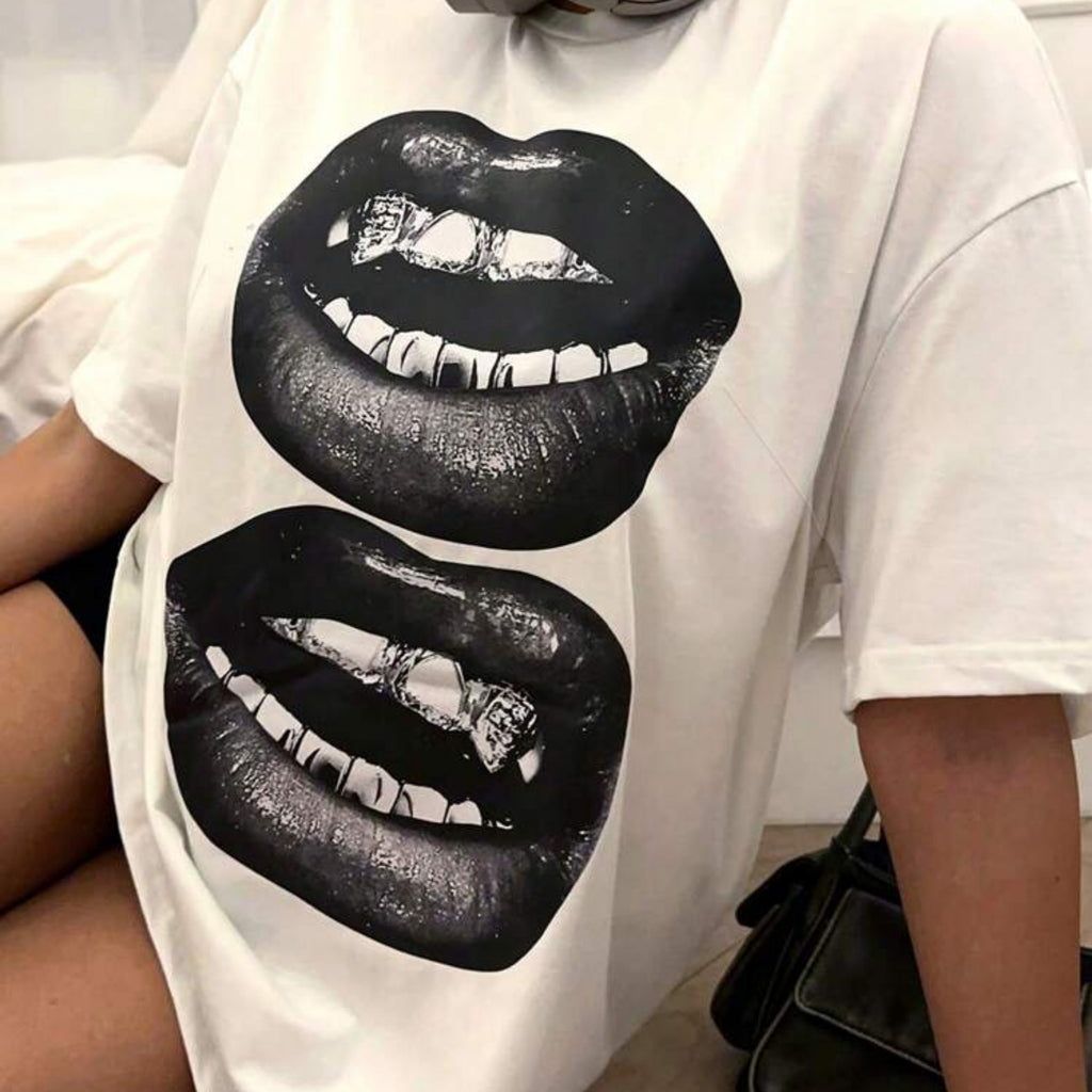 White t-shirt with black lips graphic design worn by a person.