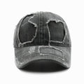 Distressed denim cap with worn-out design on a white background