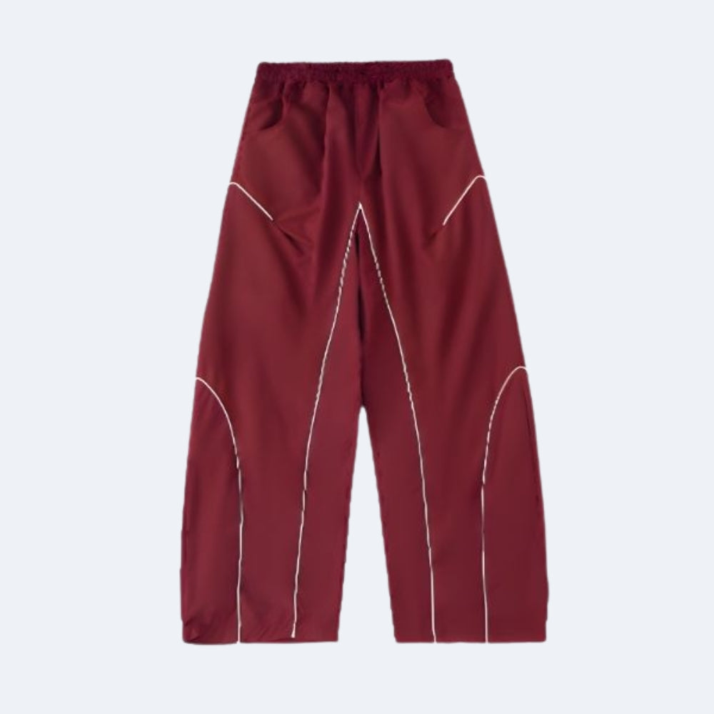 Maroon pants with white piping on a light gray background