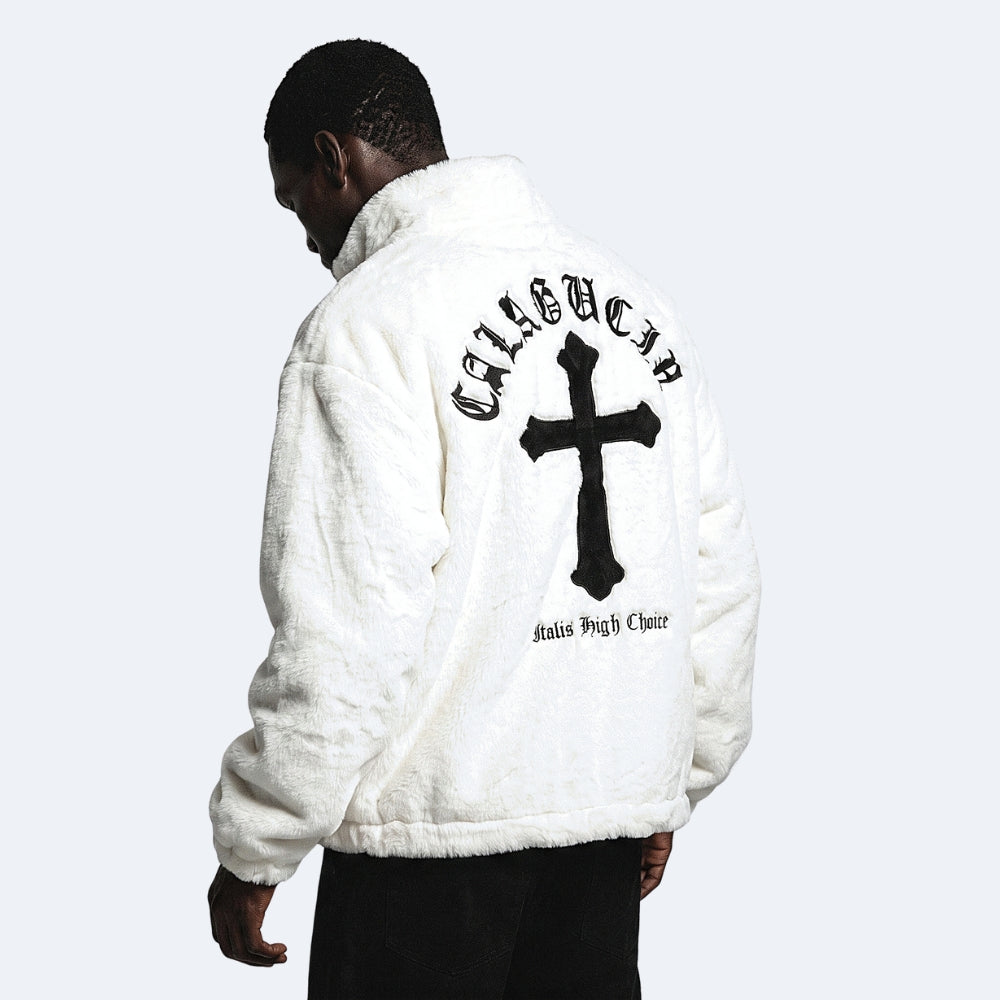 White. A man wearing a white sherpa jacket with a large black cross and gothic text on the back, shown from behind.