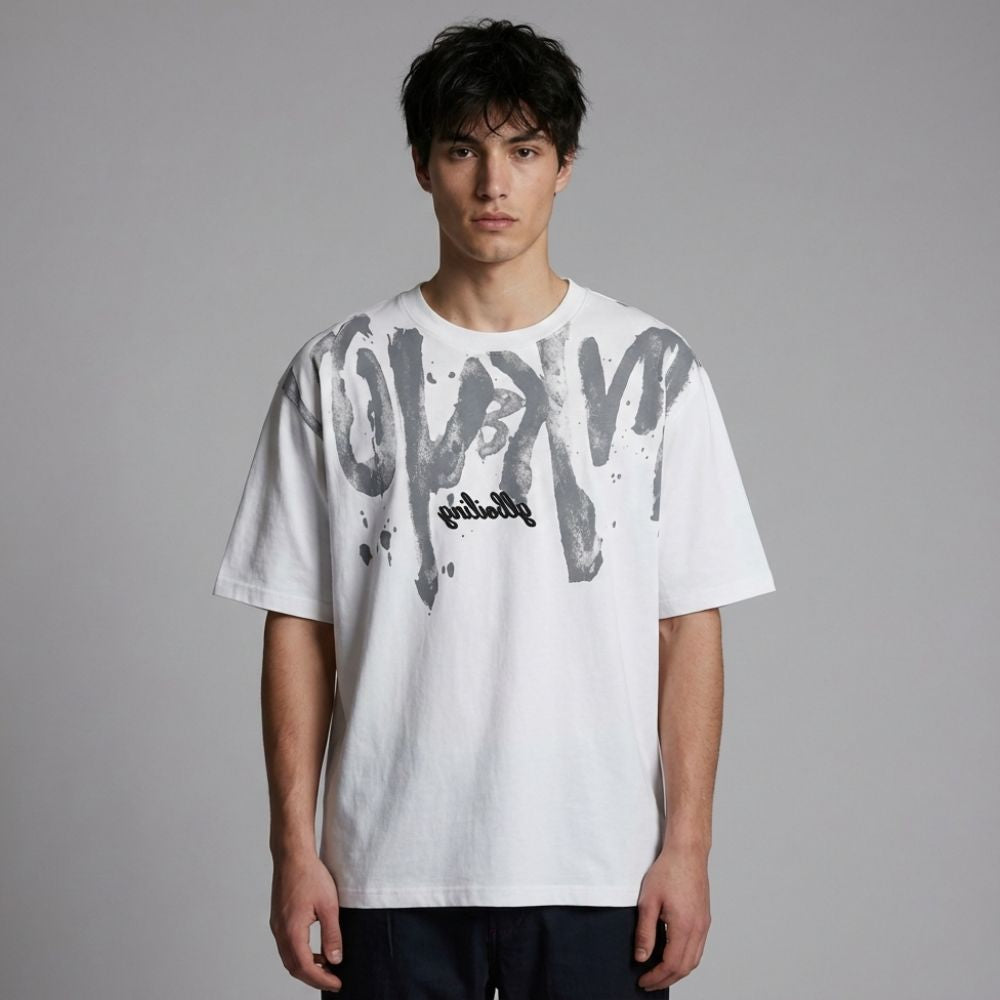 Person wearing a white t-shirt with black text and graphics on a gray background
